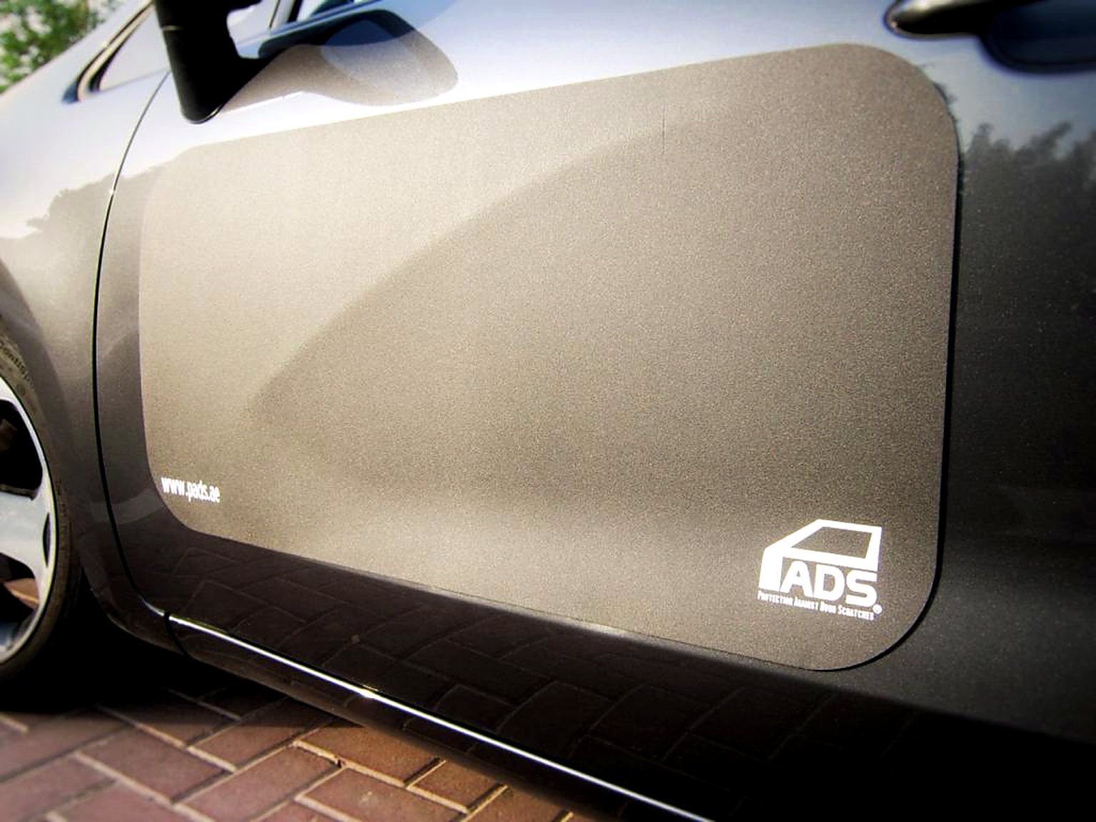 Black PADS on the door of a grey car