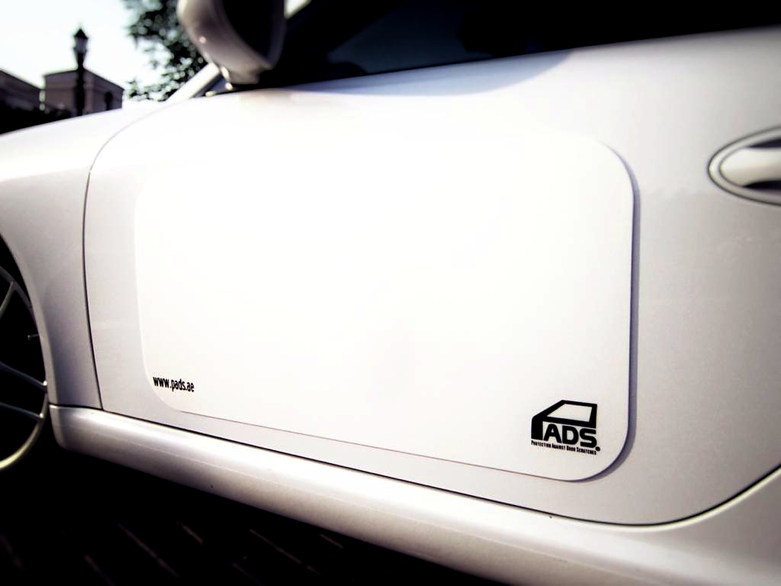 White PADS on the door of a white car
